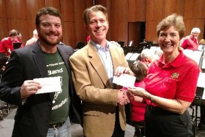 Venice Concert Band president Mary Deur presents grant checks to Venice Middle School band director Ian Ackroyd $1,640 for a xylophone, Pine View Middle School band director Victor Mongillo (center) $981 for a flute, and Laurel Nokomis Middle School band director Angela McKenzie (not pictured) $1,337 for a trombone. February 2019.
